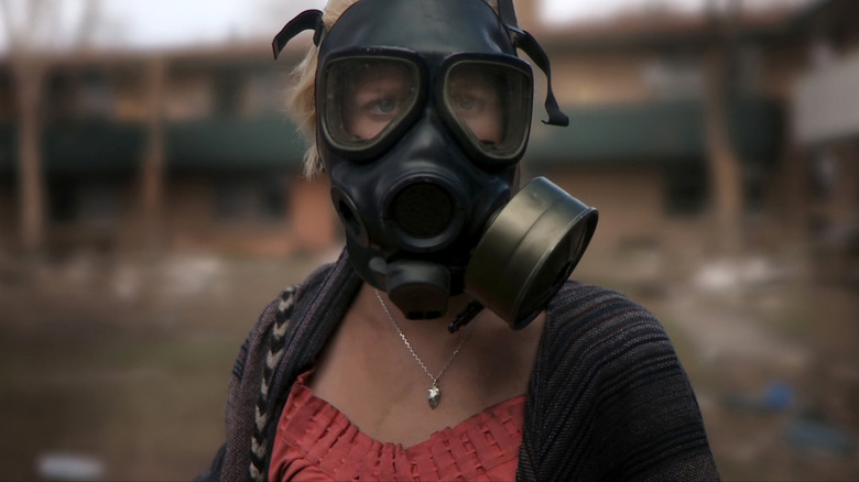 Whitney Able as Samantha Wynden in a gas mask in Monsters