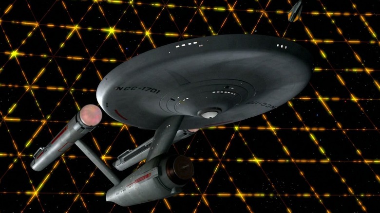 The Enterprise being surrounded by a Tholian energy net on Star Trek