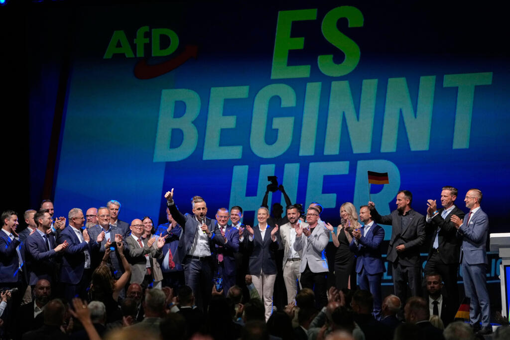 AfD candidate Ulrich Siegmund speaks in front of a poster reading "It starts here" at a rally after the Saxony-Anhalt regional elections in Magdeburg, eastern Germany, 6 September 2026.