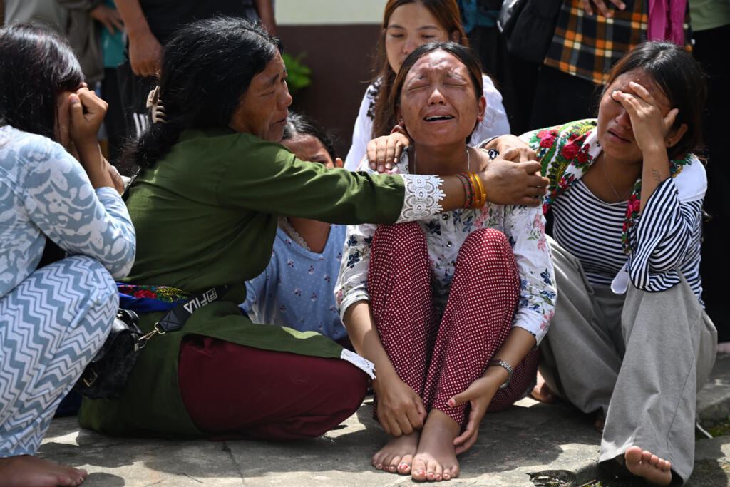 Relatives grieve during a prayer meet held for missing flash flood victims inside a Buddhist monastery at Trishuli Bazar in Nepal's Nuwakot district