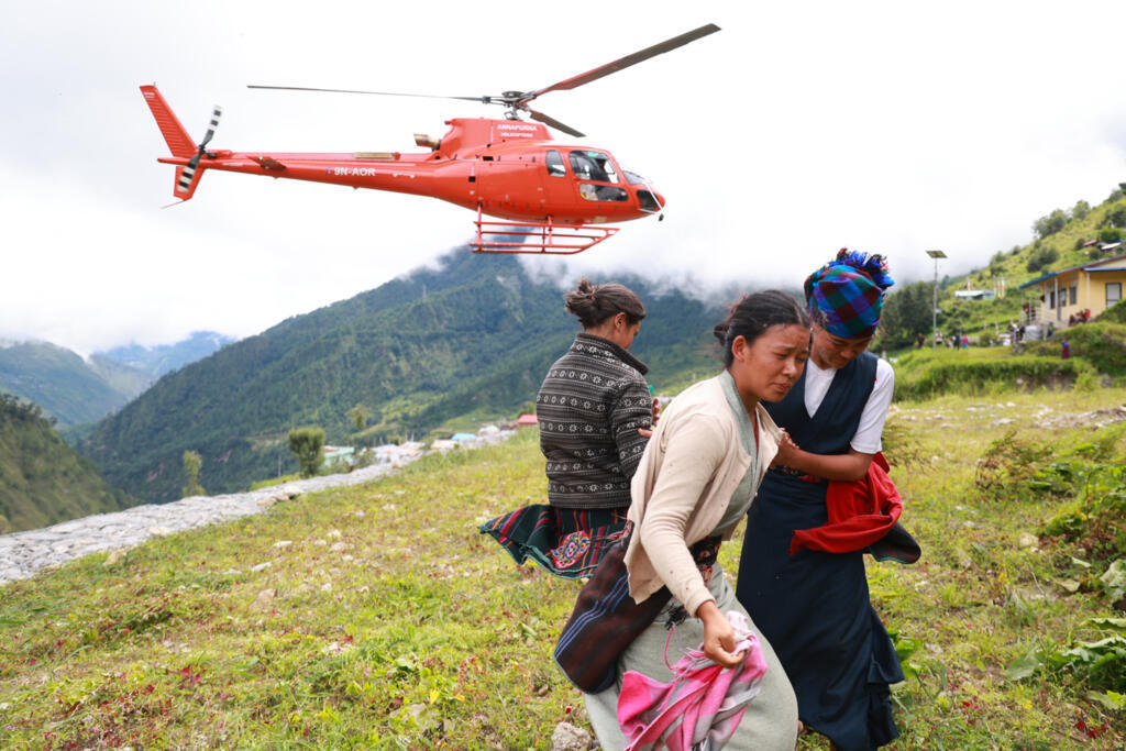 Nepal Armed Police Force helicopter carrying relief supply lands for flood affected people in Nepal's Rasuwa district