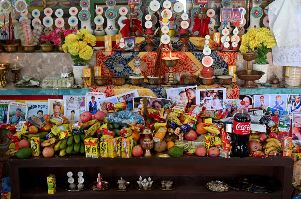 Food offerings are placed before pictures of missing flash flood victims during a prayer meet inside a Buddhist monastery at Trishuli Bazar in Nepal