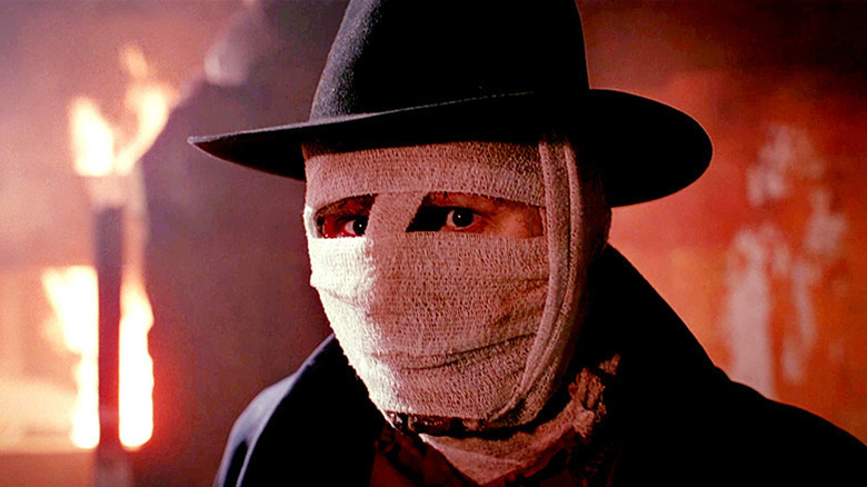 Darkman (Liam Neeson) stands with his face bandaged in Darkman