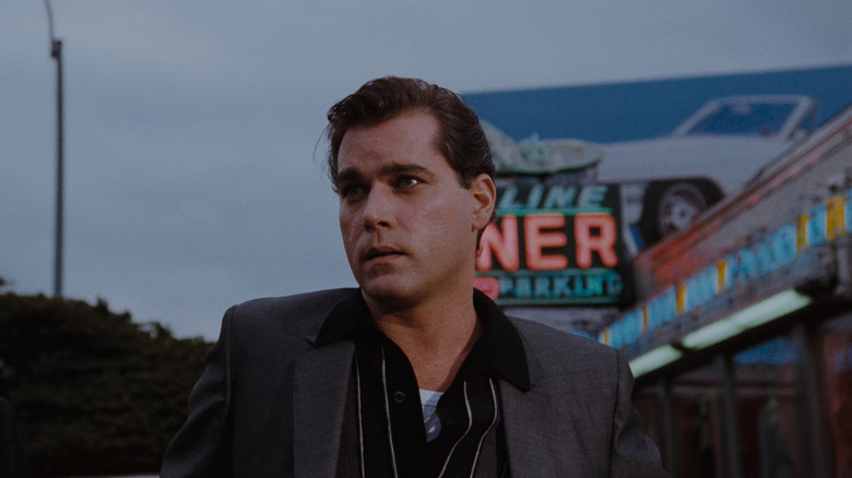 Ray Liotta as Henry Hill in Goodfellas, standing outside in front of a diner.