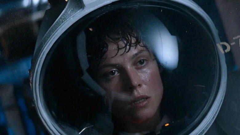 Sigourney Weaver as Ripley in Alien, looking sweaty and tired with a space helmet on.