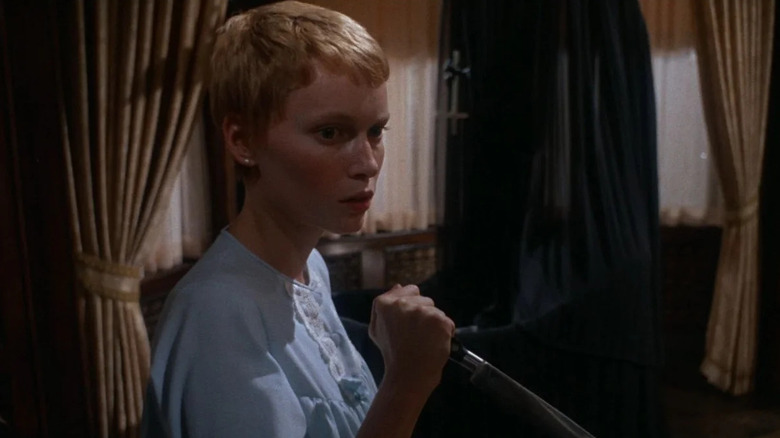 Mia Farrow as Rosemary Woodhouse in Rosemary's Baby, in her darkened apartment and wielding a dagger.