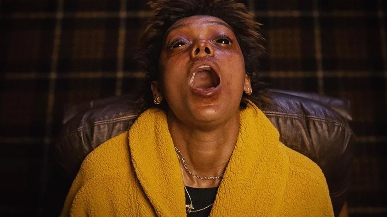 Mia (Sophie Wilde) shouts looking upward with blackened eyes in Talk to Me (2022)