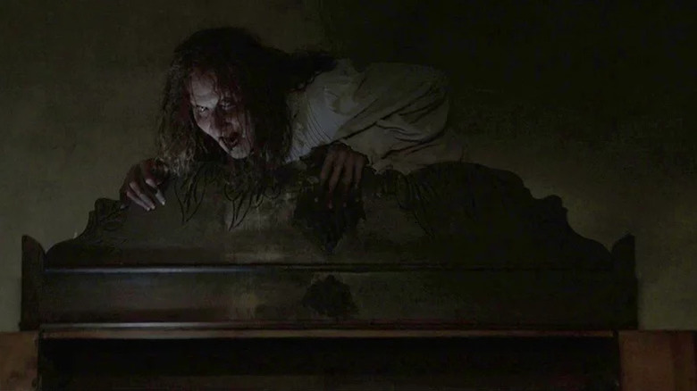 Bathsheba (Joseph Bishara) glares from the top of a wardrobe in The Conjuring