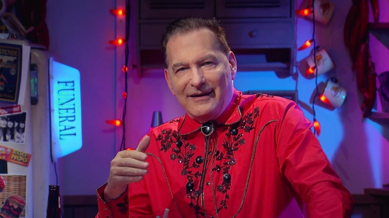 Joe Bob Briggs inside the trailer set on The Last Drive-In with Joe Bob Briggs