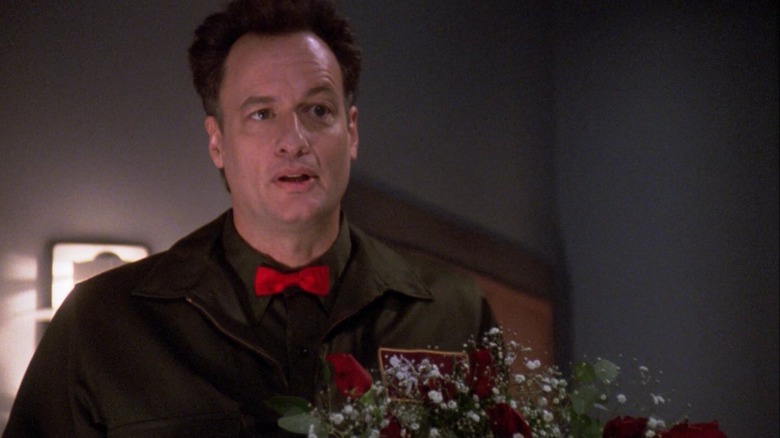 Q holding a bouquet of flowers on Star Trek: The Next Generation